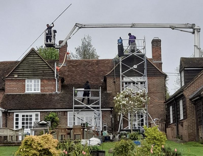 The Roof Moss Cleaners using cherry picker and scaffolding to clean roof safely and professionally in Daventry, Northamptonshire
